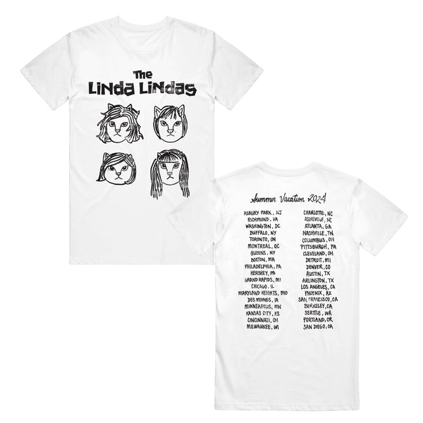 The Linda Lindas white T-shirt displays the band name and four hand-drawn faces on the front. The back highlights Summer Vacation 2024 with a bold black list of U.S. cities and states.