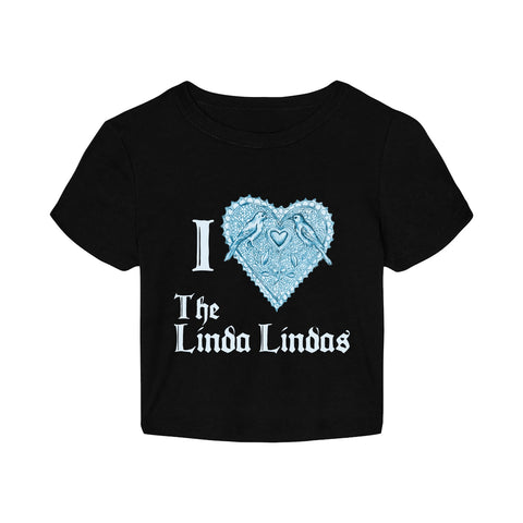 A black The Linda Lindas crop top with “I ♥ The Linda Lindas” in white gothic font. The lacy heart is accented by two blue birds. Made from Women’s Micro Rib fabric for a soft, flattering fit.