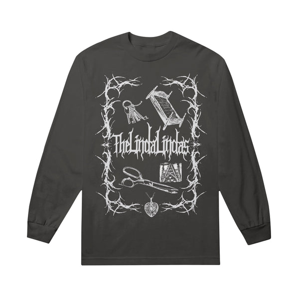 A unisex black heavyweight long sleeve shirt by The Linda Lindas featuring white gothic artwork and text, with illustrations of a key, quill, scissors, heart locket, and other objects framed by thorny branches.