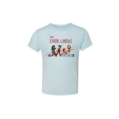 Image of an ice blue tshirt against a white background. In a red/pink text with a green outline reads "the linda lindas". Below that is an image of 4 colorful cartoon characters representing the linda lindas playing guitar, bass, and drums. in black text, The bass drum says growing up.