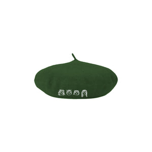 Image of a green beret hat against a white background. The hat features drawings of 4 different cat faces in white- three have shorter hair and one has longer hair. Below this in white text reads "the linda lindas". The cat faces are embroidered.