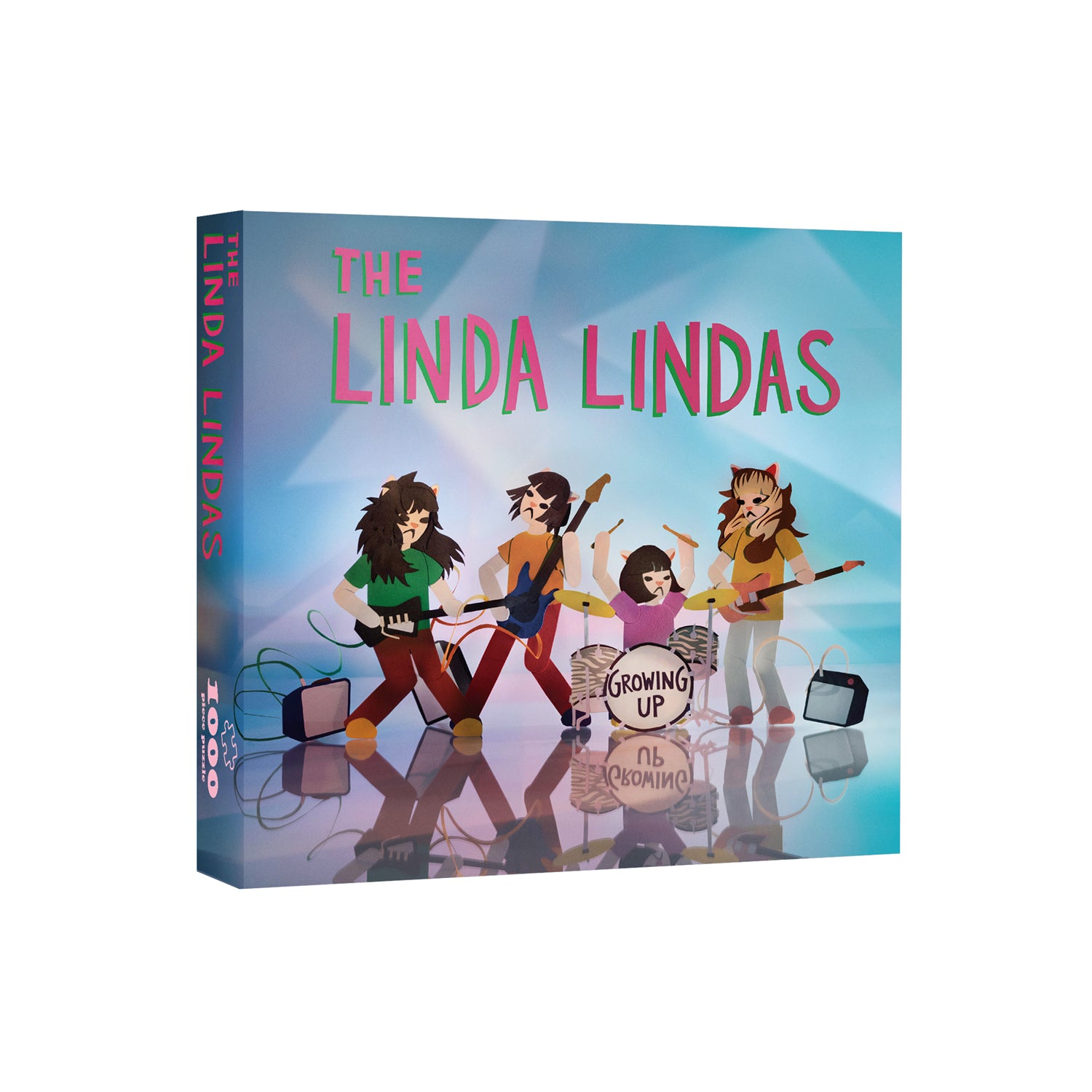 Image of a puzzle box against a white background. In a red/pink text with a green outline reads "the linda lindas". Below that is an image of 4 colorful cartoon characters representing the linda lindas playing guitar, bass, and drums. in black text, The bass drum says growing up. The background on the puzzle box is a mix of blue, purple, and green. On the side of the poster box, it says the linda lindas, 1000 piece.