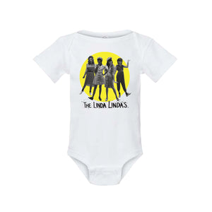 Image of a white baby onesie against a white background. The center of the onesie features a yellow circle- inside the circle is a black and white image of the linda lindas standing and facing the camera. Below that in black thin writing reads "the linda Lindas".