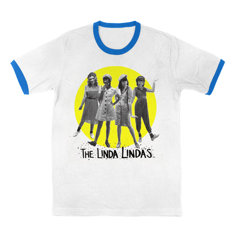 Image of a white tshirt against a white background. The center of the shirt features a yellow circle- inside the circle is a black and white image of the linda lindas standing and facing the camera. Below that in black thin writing reads "the linda Lindas". The cuffs of the sleeves and the neckline of the tee are blue.