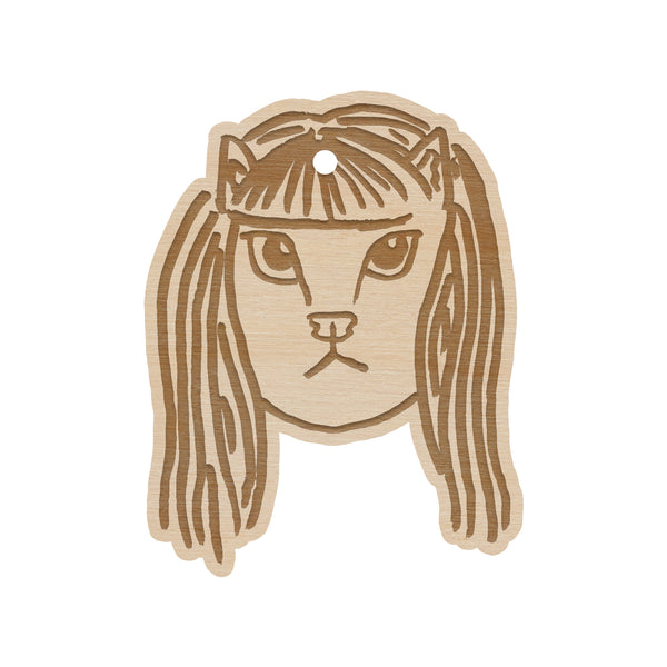 wooden ornament on a white background of a cat head member of the linda lindas