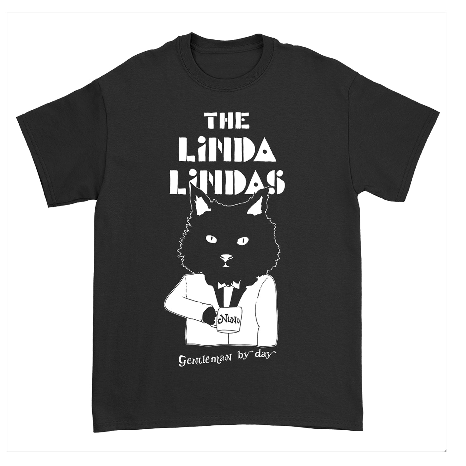 Image of a black tshirt against a white background. The Center of the shirt says the linda lindas in white blocky text. Below that is a graphic of a black cat from the waist up. The cat is wearing a suit and holding a cup of coffee. The coffee cup says "Nino". Below this in thin white text reads "gentleman by day".
