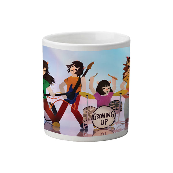 Image of a white coffee mug against a white background. The photo features the linda lindas- growing up- album artwork. This photo of the mug shows four cat cartoon graphics playing instruments. The drum kit says growing up. The background is a mix of white and light teal color.
